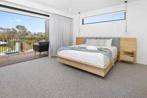 a bedroom with a bed and a balcony at Cambridge Gardens - Sorrento Luxury with Gas Heated Spa, Solar Heated Pool in Sorrento +28 photos