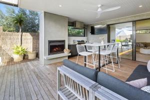 a living room with a couch and a fireplace at Cambridge Gardens - Sorrento Luxury with Gas Heated Spa, Solar Heated Pool in Sorrento