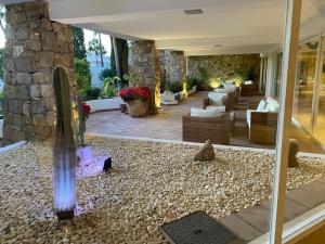 a lobby of a hotel with a stone wall at Stunning suite at Hotel Del Golf, 5 stars and frontline Golf, Porto Banus, Marbella in Marbella