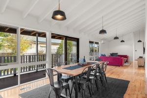 a dining room with a table and chairs at Retreat on Red Rocks in Cowes