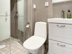 a bathroom with a toilet and a sink and a shower at 4 star holiday home in Edsbruk in Edsbruk