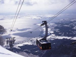 a gondola ride up a snowy mountain with a lake at Lake Biwa Otsu Prince Hotel in Otsu