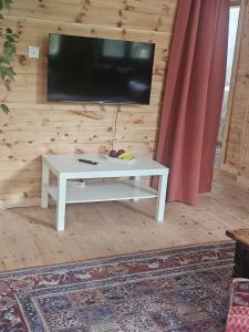 a white coffee table with a flat screen tv on a wall at Gemütliche Wohnung mit Sauna in Neumarkt in der Oberpfalz