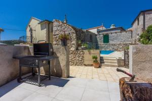a desk with a computer on it next to a wall at Casa Royal in Bribir