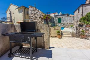 a barbecue grill sitting on the side of a building at Casa Royal in Bribir +75 photos