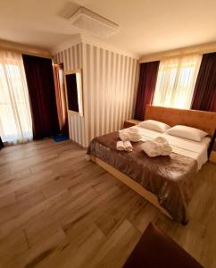 a bedroom with a bed with two towels on it at Dreamvilla tbilisi hotel in Tbilisi City