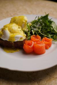 a plate of food with an egg and vegetables at Deluxe apartments Canggu area with gym coworking security parking and full services in Tumbak Bayuh