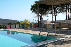 a swimming pool with a slide in the middle at Hippie Bay Complex in Porto Rafti