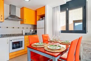 a kitchen with a red dining table and orange chairs at Tropikana Paradise Miami in Miami Platja