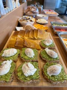 a buffet of food with bread and eggs on toast at Villa White in Ksamil