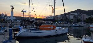 a boat is docked in a marina with the sunset at Yacht Pipit in Kavala +16 photos