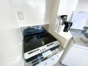 4F Guest House NETOMARI 西九条駅から徒歩2分にあるキッチンまたは簡易キッチン