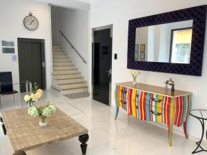 a living room with a table and a mirror at Feelathome Rivero Apartments in Seville