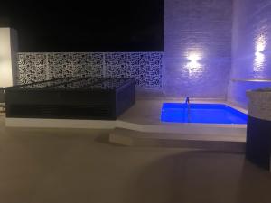 a bathroom with a blue tub in a room at Feelathome Rivero Apartments in Seville