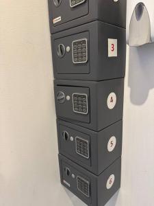 a stack of four control boxes on a wall at EksPorta Apartments 6 in Rīga