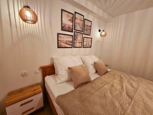 a bedroom with a bed and some pictures on the wall at Pogodne Wzgórze in Wapnica