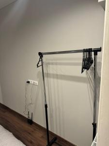 a shower curtain in a room next to a bed at EksPorta Apartments 6 in Rīga +4 photos