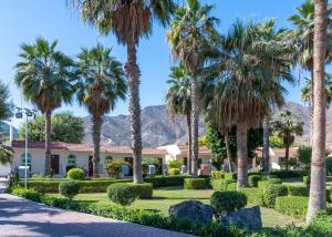 a resort with palm trees and a building at Sandy Beach Hotel & Resort in Al Aqah