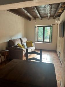 a living room with a couch and a table at La Posada De Alanah in Candeleda +34 photos