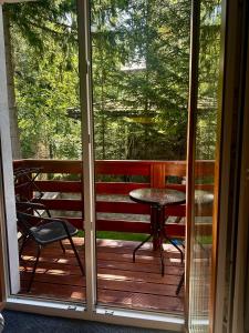 a screened in porch with a table and a chair at Willa Strumyk in Karpacz +22 photos