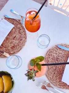 a white table topped with plates of food and a drink at Hotel Albatros in Ischia
