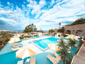 a large swimming pool with umbrellas and chairs at Parco dei Principi Resort & Spa in Forio d'Ischia