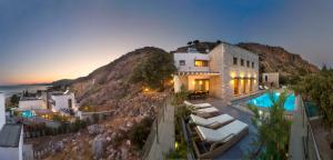 a house on a hill with a swimming pool at Blue Dream Exclusive villas privees in Pefki Rhodes