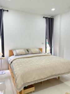 a bedroom with a large bed with black curtains at JK Studio, Koh Yao Noi in Ko Yao Noi