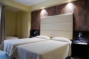 Postel nebo postele na pokoji v ubytování Hotel Pineta Palace