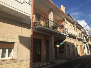 a building with a balcony on the side of a street at La Rosa Antica in Avetrana