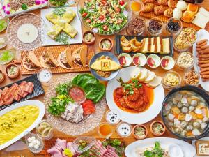 a table topped with lots of plates of food at APA Hotel & Resort Osaka Namba Ekimae Tower in Osaka