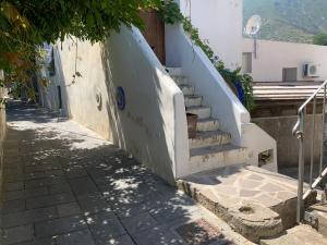 a set of stairs next to a building at Casa Pomelia - in centro a Malfa in Malfa