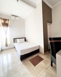 Ένα ή περισσότερα κρεβάτια σε δωμάτιο στο Capital Panorama Guest House Syariah