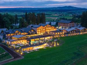 an aerial view of a large building with lights at PANORAMA Allgäu Spa Resort in Seeg