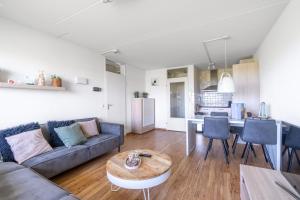 a living room with a couch and a table at Appartementencomplex Juliana 102 in De Koog