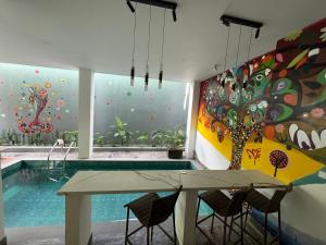 a dining room with a pool and a painting on the wall at Serene Villa Icaro in Downtown El Nido with Cliff View in El Nido +76 photos