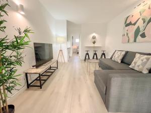 a living room with a couch and a flat screen tv at La Casa de Las Rosas in Costa de Antigua