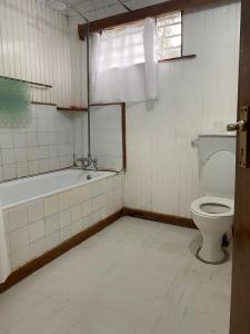 a bathroom with a toilet and a bath tub at My Lily Cottage Naivasha in Naivasha +73 photos