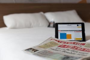 Łóżko lub łóżka w pokoju w obiekcie Brit Hotel Toulouse Colomiers – L’Esplanade