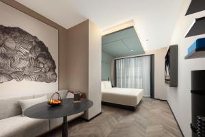 a living room with a couch and a table at Atour S Hotel Tianshan Road in Shanghai