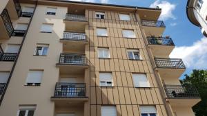 an apartment building with balconies on the side at Apartman Savic 1 Centar in Bijeljina