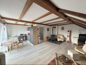 a living room with a table and a kitchen at Must love dogs in Koblenz
