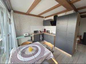 a small kitchen with a table with a yellow bowl on it at Must love dogs in Koblenz