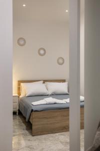 a bedroom with a bed with white walls at Ourania Apartment 2 in Pentati