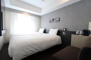 Postel nebo postele na pokoji v ubytování KOKO HOTEL Ginza-1chome