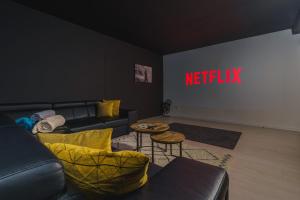 a living room with a couch and a netflix sign at Diamond Villa, luxury house with private pool in Lourinhã