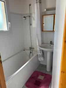 a bathroom with a bath tub and a sink at Les aigrettes in Saint-Pierre-dʼOléron +11 photos