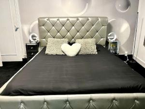 a bedroom with a large bed with a heart pillow at Wonderlove cocon - coeur de Nantes, cathédrale in Nantes +34 photos
