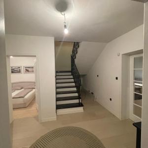 a staircase in a room with a bed and a stair case at Villa Elezovic in Čapljina