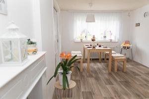 a white kitchen with a table and a dining room at Ferienhaus "Am Staufenberg" in Blankenburg